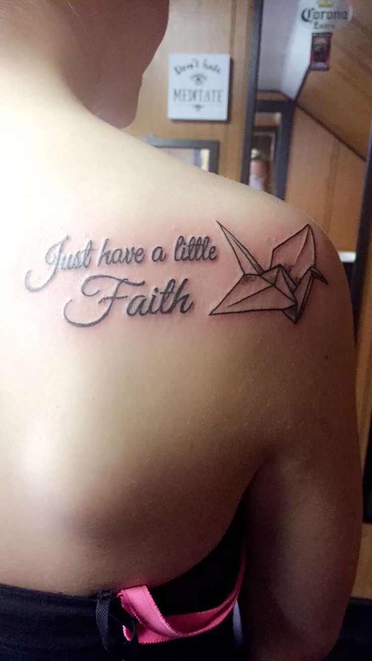 a woman with a tattoo that says just have a little faith on her upper back