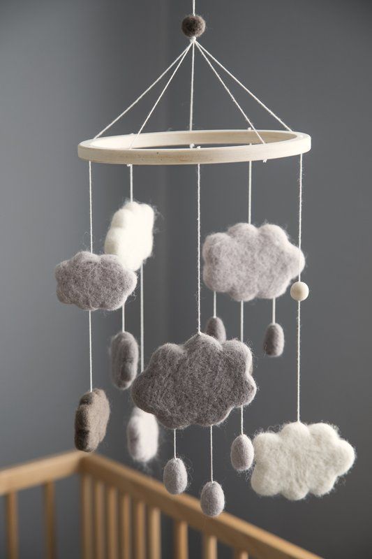 a crib mobile with clouds hanging from it