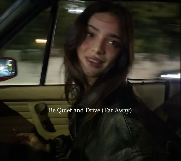 a woman sitting in the passenger seat of a car