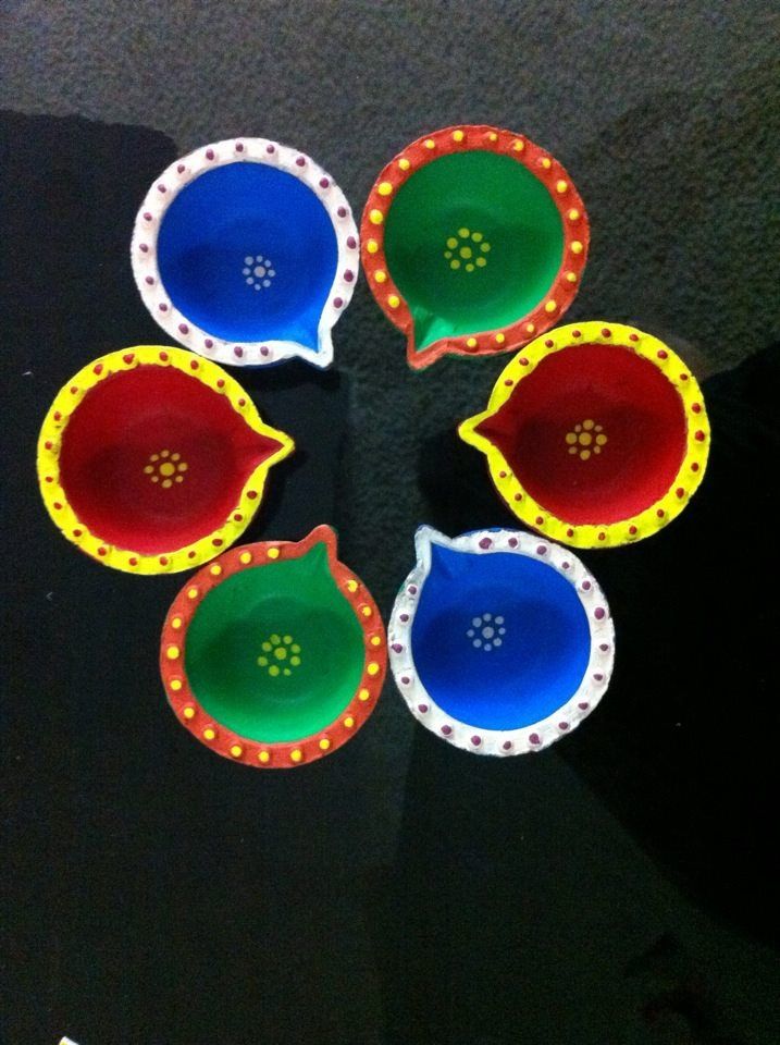 five colorful bowls sitting on top of a black table