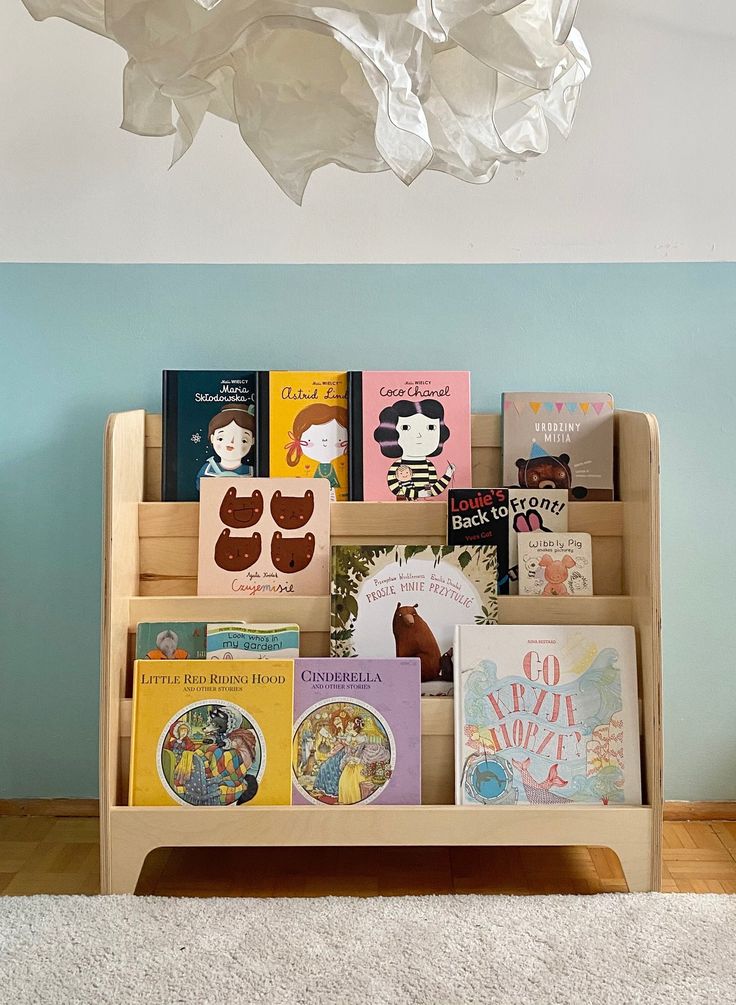 there is a book rack with many books on it in the living room and blue walls