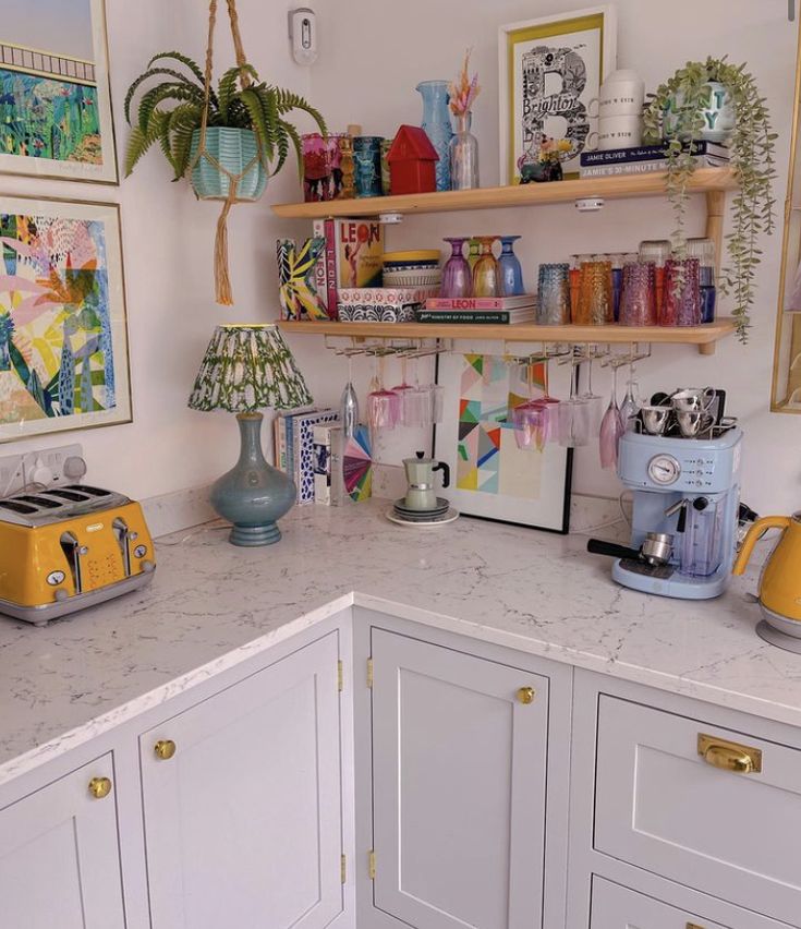 a kitchen with white cabinets and lots of clutter on the counter top next to a yellow toaster