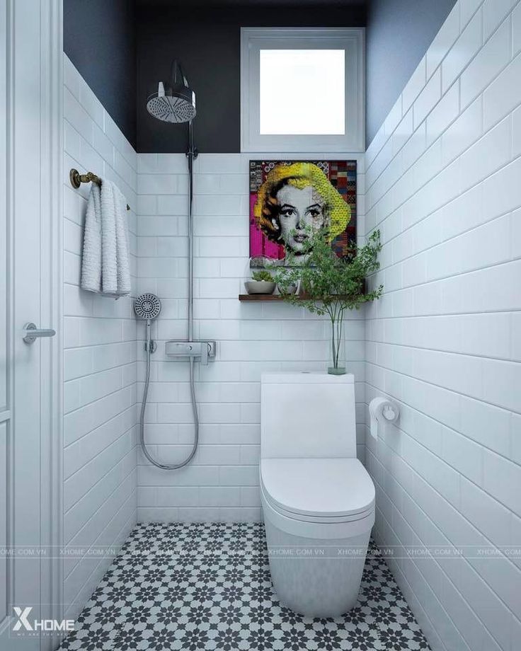 a white toilet sitting in a bathroom next to a shower head and hand dryer