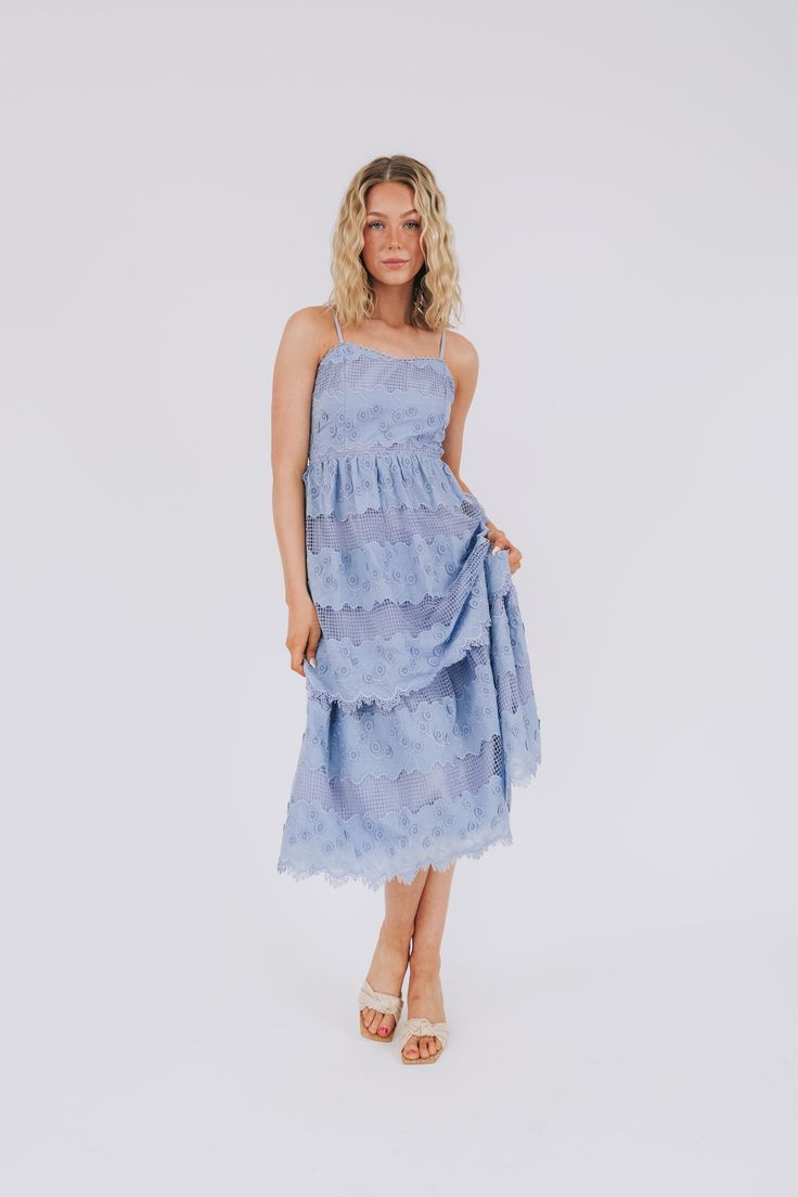 Get ready to embrace your feminine side with The Feminine Urge Dress! This playful dress features tiered layers, a back cut out for added flair, and is fully lined for comfort. The delicate lace-like and floral embroidery adds a touch of whimsy to this must-have piece. Time to show off your feminine urge! Details Tiered Back cut out Fully lined Lace-like/floral embroidery Sizing Approximate measurements: SIZE LENGTH BUST Small 49" 34" Medium 51" 36" Large 51" 38" Fabric has no stretchModel is 5’ Spring Dress With Scalloped Lace And Spaghetti Straps, Tiered Spring Dress With Layered Hem, Spring Tiered Skirt Midi Dress With Layered Hem, Spring Midi Dress With Layered Tiered Skirt, Spring Layered Dress With Spaghetti Straps, Spring Midi Dress With Scalloped Lace For Garden Party, Chic Tiered Lace Dress With Ruffles, Lace Tiered Skirt Dress For Brunch, Feminine Tiered Lace Dress