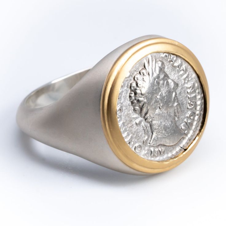 Item Description: Authentic Roman Coin encased in ring. Ring available in solid 18K gold or solid 925 silver with 18K gold bezel and logo. Each piece comes with a certificate of authenticity. Please note some sizes may require longer lead times due to inventory constraints. Authentic Coin Details: Coin Type & Age: Silver Denarius, 161-180 ADEmperor: Marcus AureliusDiameter/Weight: 17.5 - 18.5 mm / 3 - 3.8 gFront/Back: Portrait of Emperor / Mythological & Military Themes The Stoic philosopher-kin Back Portrait, The Stoics, Roman Coins, Silver Signet Ring, Hammered Rings, Marcus Aurelius, Alexander The Great, 18k Gold Ring, Old Coins