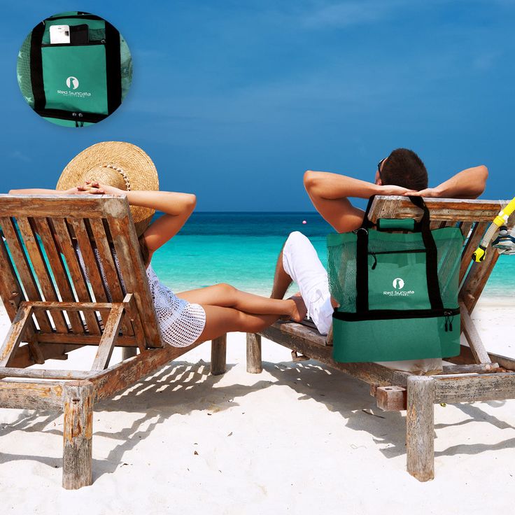 two people sitting in chairs on the beach with their backs to each other, facing the ocean