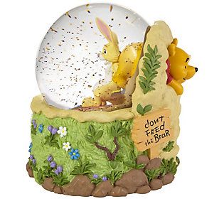 a snow globe with winnie the pooh and piglet in it on top of rocks