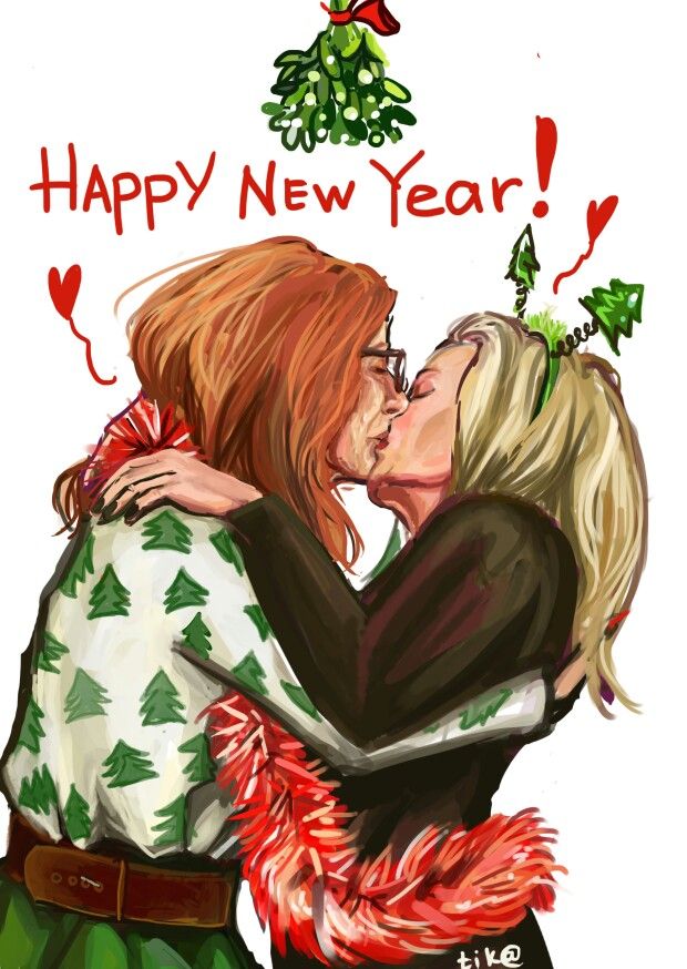 two women hugging each other in front of a christmas tree and the words happy new year