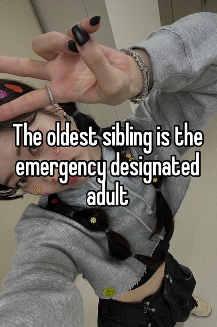 a woman with her hand in the air and texting, the oldest sibling is the emergency designated adult