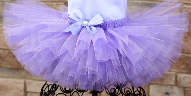 A stunning, fluffy lavender tutu All tutus are made with high quality tulle and a 1" non-roll waist band.  I make all my tutus very full and fluffy.  I put as much tulle as I can possibly fit.  When measuring your child's waist, order the size that is 2 inches smaller than her actual waist since the band is made of elastic. Tutu Size Chart 0-6 mo         14" waist    6"length 6-12 mo       15"waist     6"length 12-24 mo     16"waist     7"length 2Toddler      17"waist     7"length 3Toddler Tutu Size Chart, Tutu Shirt, Girls Clothing Sets, Clothing Sets, Girls Clothing, Waist Band, Mother’s Day, Outfit Sets, Lavender