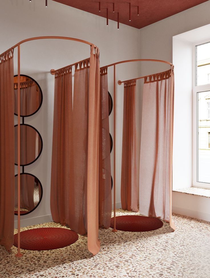 three round beds with sheer curtains in a room