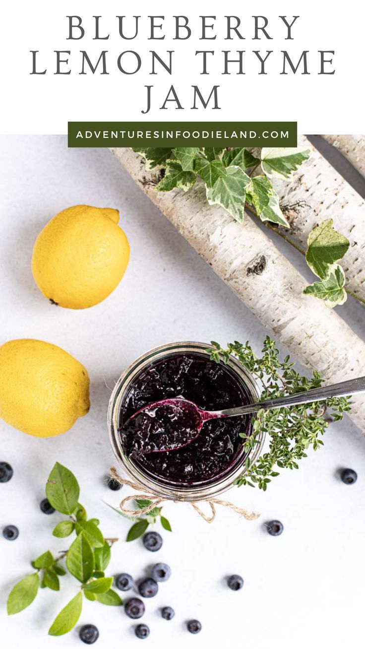 blueberry lemon thyme jam in a jar with fresh berries and leaves around it