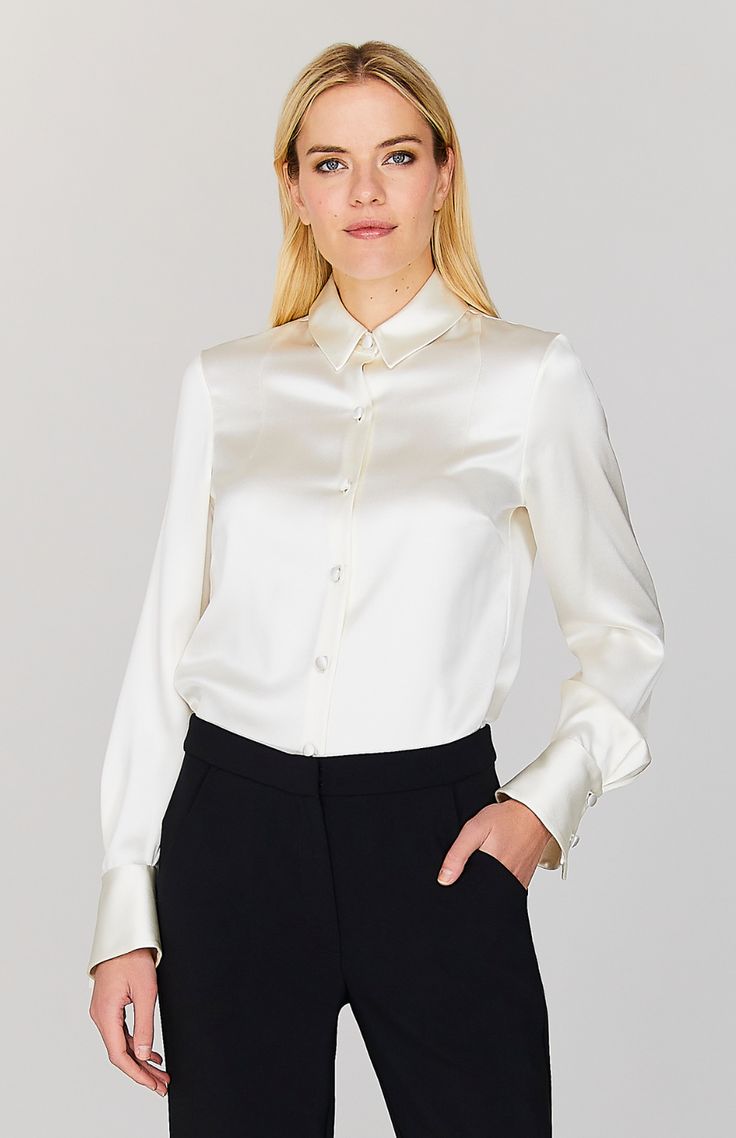 Our signature collared button down shirt is an elegant update to a wardrobe staple. Cut with a beautifully drapey and relaxed sleeve and finished with a wide angled cuff that can be worn long or folded up for maximum versatility. An easy way to add a pop of color and shine under a jacket, but strong enough to stand alone. Semi-formal Sleek Collared Blouse, Elegant Semi-formal Tops With Lapel Collar, Elegant Semi-formal Shirt With Covered Buttons, Chic Silk Shirt With Hidden Button Closure, Timeless Office Blouse With Lapel Collar, Elegant Silk Button-up Top, Elegant Long Sleeve Dress Shirt For Daywear, Elegant Button-up Shirt For Fall, Elegant Fall Button-up Shirt