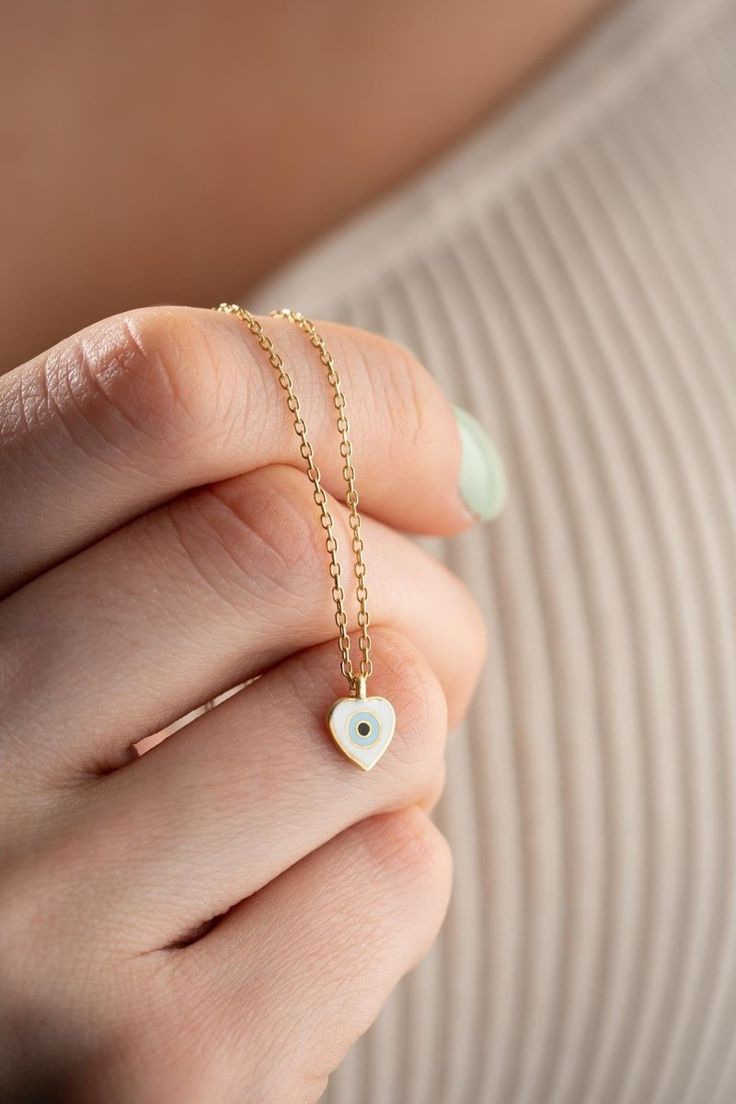 Shine with Minimal Elegance: 925K Sterling Silver Gold Plated Enamel Heart Necklace Add a touch of timeless sophistication to your look with the Silver Gold Plated Enamel Minimal Heart Necklace. This necklace is crafted from genuine 925 sterling silver, ensuring its quality and durability. The delicate gold plating adds a touch of warmth and complements the minimalist heart-shaped pendant, creating a piece that's both classic and eye-catching. 925 Sterling Silver is renowned for its elegance and Dainty White Heart Necklace For Her, White 14k Gold Necklace With Heart Charm, White Sterling Silver Heart Necklace, White Polished Necklaces For Everyday, Everyday White Necklaces With Polished Finish, White 14k Gold Heart Necklace For Gift, 14k Gold White Heart Necklace For Gift, White Heart Fine Jewelry Necklace, White Heart Charm Necklace In Fine Jewelry Style