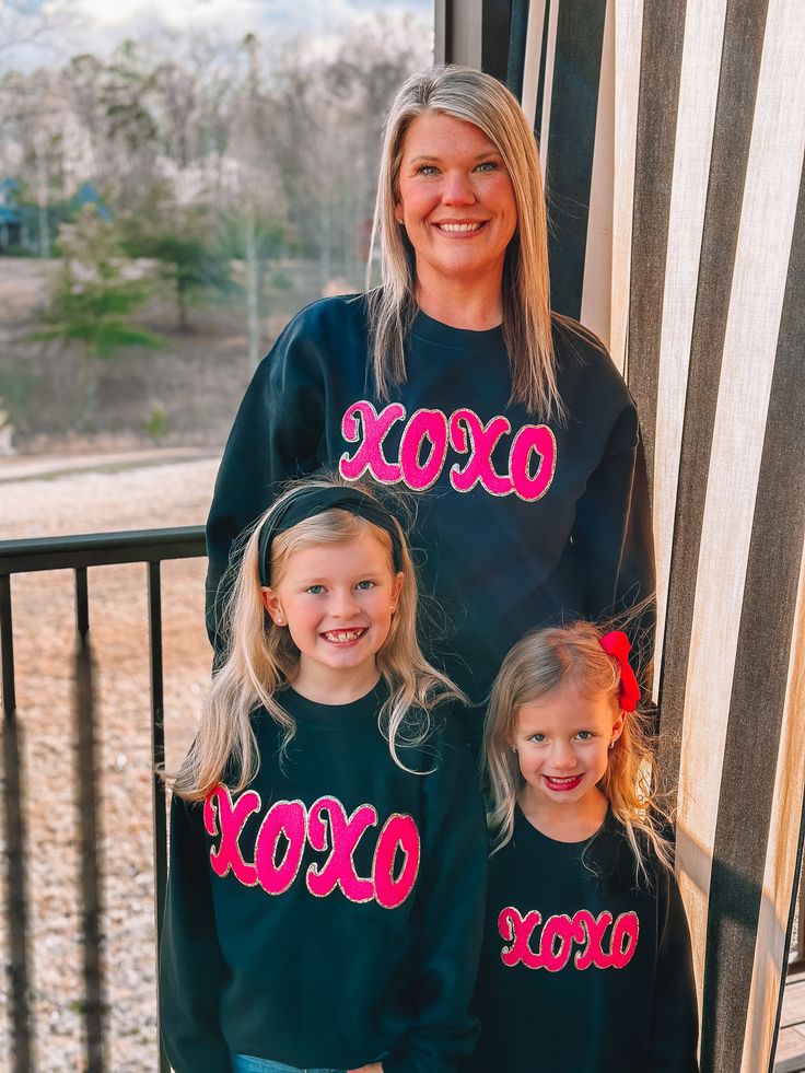 Look how CUTE! This hot pink XOXO chenille pops on this black sweatshirt! The amazing thing about this sweatshirt is that it is available from 2T - Adult 3XL!! Match with your little ones this Valentine's Day with this adorable sweatshirt! You will definitely get compliments! This is one of our favorites! Unisex sizing and fit Size: 2T - Adult 3XL SPECIAL CARE - WASHING INSTRUCTIONS: Hand washing and air drying are always best for these items. Wash on delicate, cold, and inside out. Always air d Cute Black Crew Neck Sweater, Black Letter Print Fun Sweatshirt, Cute Black Sweatshirt For Fall, Cute Black Sweatshirt With Letter Print, Cute Black Fall Sweatshirt, Fun Black Sweatshirt With Graphic Print, Black Sweatshirt, Washing Instructions, Hand Washing