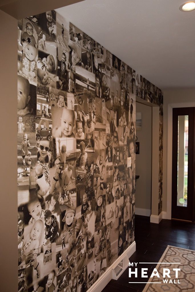 a wall with many pictures on it next to a door and carpeted flooring