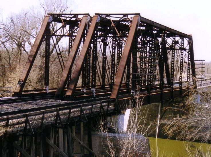 an old train bridge over a body of water