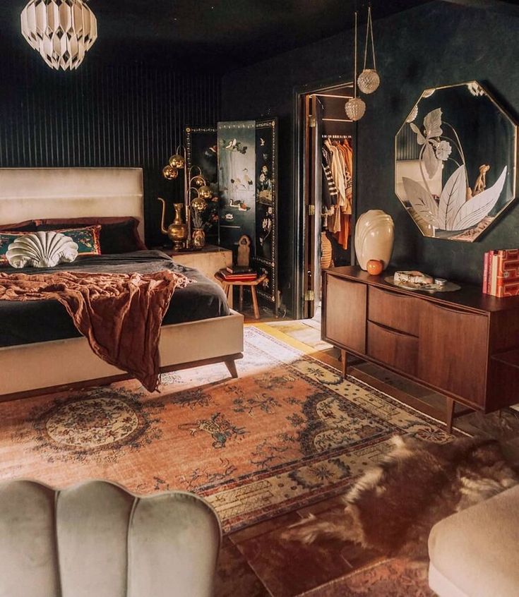 a bedroom with a bed, dressers and mirror on the wall next to it