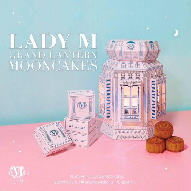 an advertisement for lady m's grand layer mooncakes on a pink table