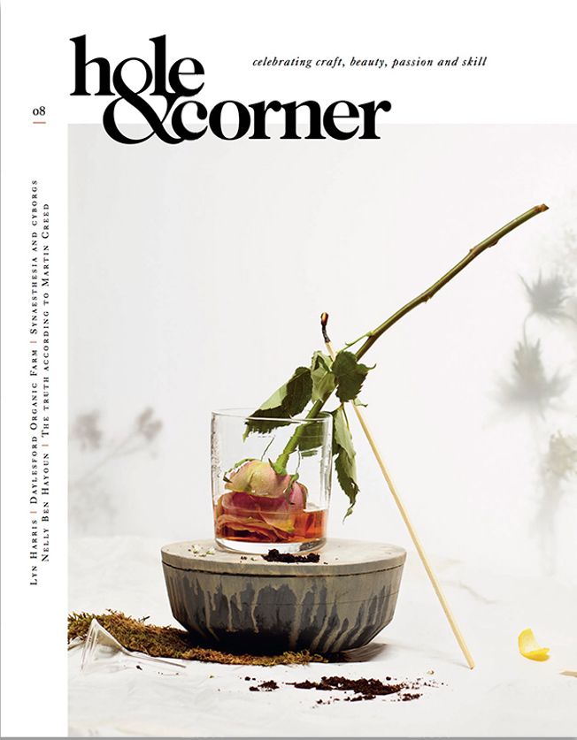 a magazine cover with an image of a flower in a vase on top of a table