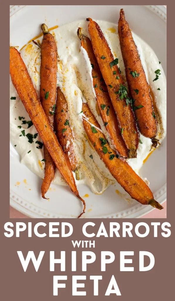 baked carrots with whipped feta on a white plate