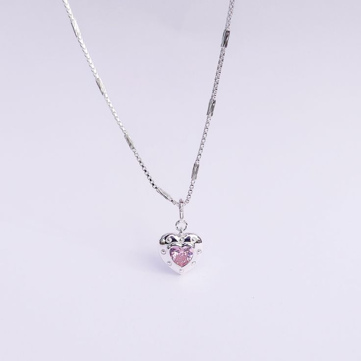 Introducing our Pink Glam Heart Necklace - crafted in Sterling Silver with a heart-shaped pink crystal at its core. This unique chain necklace features a sparkling pink crystal heart pendant, on a Sterling Silver heart shape base adding sophistication to any look. Wear it long or short with the adjustable clasp. Elevate your style with this enchanting piece that radiates love and glamour. Main Stone: heart shaped lab diamond Stone Color: pink Metal Material: 925 Sterling Silver Chain Lenght: 16 Silver Heart-shaped Crystal Necklace With Clavicle Chain, Pink Heart Charm Round Pendant Jewelry, Pink Round Pendant With Heart Charm, Pink Round Pendant Jewelry With Heart Charm, Silver Heart Crystal Necklace, Crystal Heart Jewelry With Heart Charm, Silver Crystal Clavicle Necklace With Heart Pendant, Heart Charm Crystal Jewelry, Valentine's Day Heart Pendant Crystal Necklace