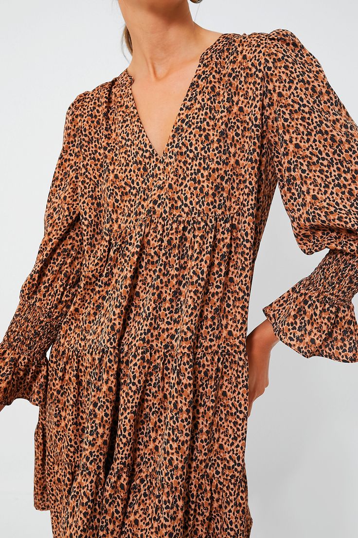 Meet one of our favorite silhouettes, the Kenzo Dress. Featuring feminine flutter smocked cuffs, a V-neckline, and a loose empire waist, this is the most flattering flirty frock! Pair this leopard mini with flats for a casual look or dress up with heels and statement earrings for date night. V-neckline Long sleeves Elasticated ruffle cuff Loose empire waist Tiered skirt Swing shape Mini length Crepe fabric Material: 100% Polyester Care: Machine wash cold Kenzo Dress, Crinkled Fabric, Blossom Print, Plus And Minus, Tier Skirt, Crepe Fabric, Tiered Skirt, Empire Waist, Casual Look