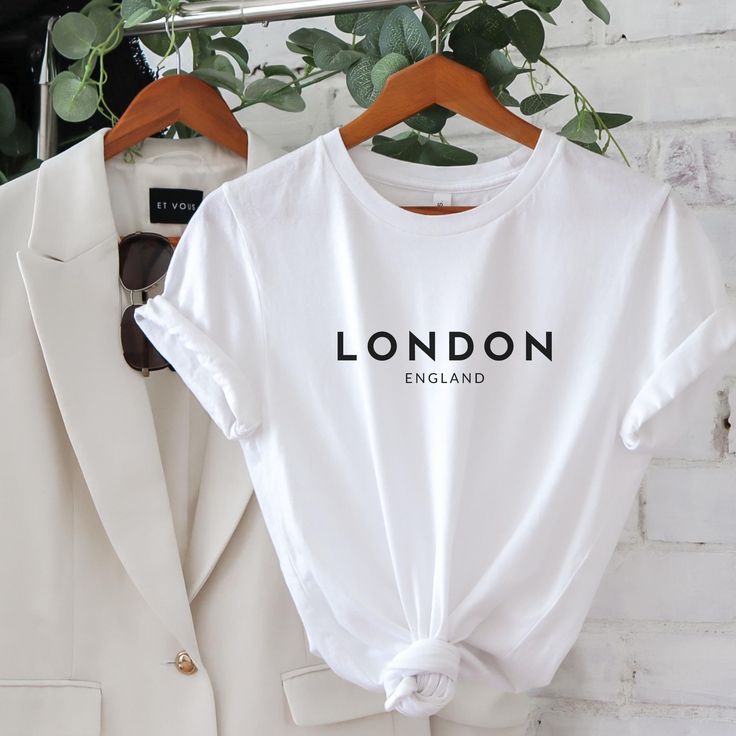 London England Soft Cotton T-shirt. Made With Love & Purpose. This T-shirt is a Love at first sight. There's nothing better than a shirt that makes you feel comfortable and stylish at the same time. Style this modern London T-shirt with a skirt, jeans or leggings, add a piece of jewelry, put on your favorite shoes and you're ready to go make memories. This tee makes a perfect gift for all London/Fashion Lovers. GENERAL INFORMATION - Bella And Canvas Brand Shirts - Unisex Adult Sizing - Rolled Sl Sublimacion Ideas, Minimalist Clothing, French Gifts, Skirt Jeans, Paris Girl, Paris T Shirt, Sleeves (women), White Casual, Minimalist Outfit