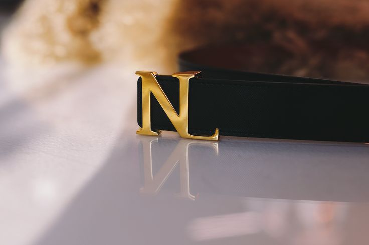 Introducing Buckle Up | NL Belt, the perfect accessory for any outfit. Made with real genuine leather and featuring a NL stainless steel logo dipped in gold, this belt is both stylish and durable. Plus, its reversible design and included NL key make it a versatile and convenient addition to your wardrobe. Made from 100% Real Leather. Stainless steel buckle, dipped in gold to give it that elegant finish. XS26(25/26/27) / S:28(26/27/28) (L: 95CM) M:30 (29/30/31) / L:32(31/32/33) (L:100CM) XL 34 (3 Gold Business Belts With Metal Logo, Gold Belts With Metal Logo For Business, Gold Belt Buckle With Metal Logo For Formal Occasions, Modern Gold Belt With Metal Logo, Elegant Gold Belt With Metal Logo, Elegant Gold Belt As Gift, Elegant Gold Belt For Gift, Steel Logo, Belt Buckles