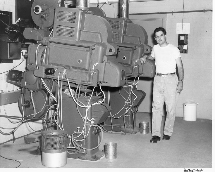 a man standing next to a large machine