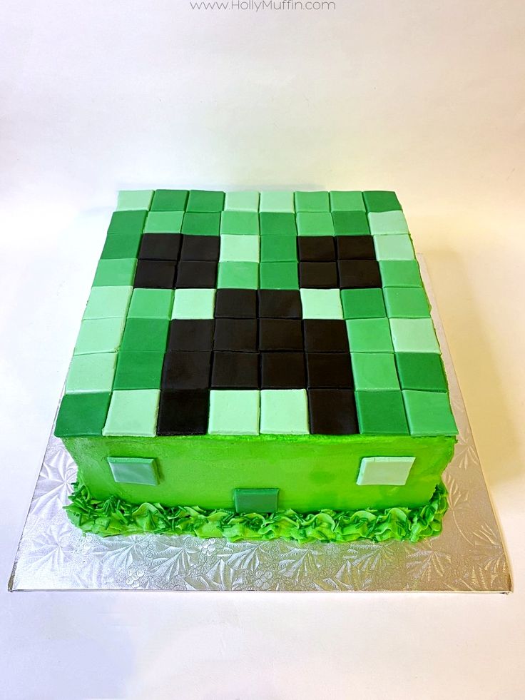 a green cake with black squares on it