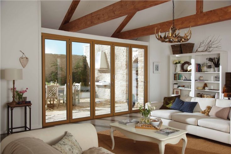 a living room filled with furniture and windows