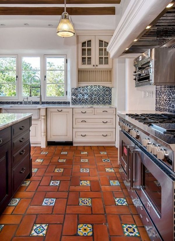 a kitchen with tile flooring and white cabinets