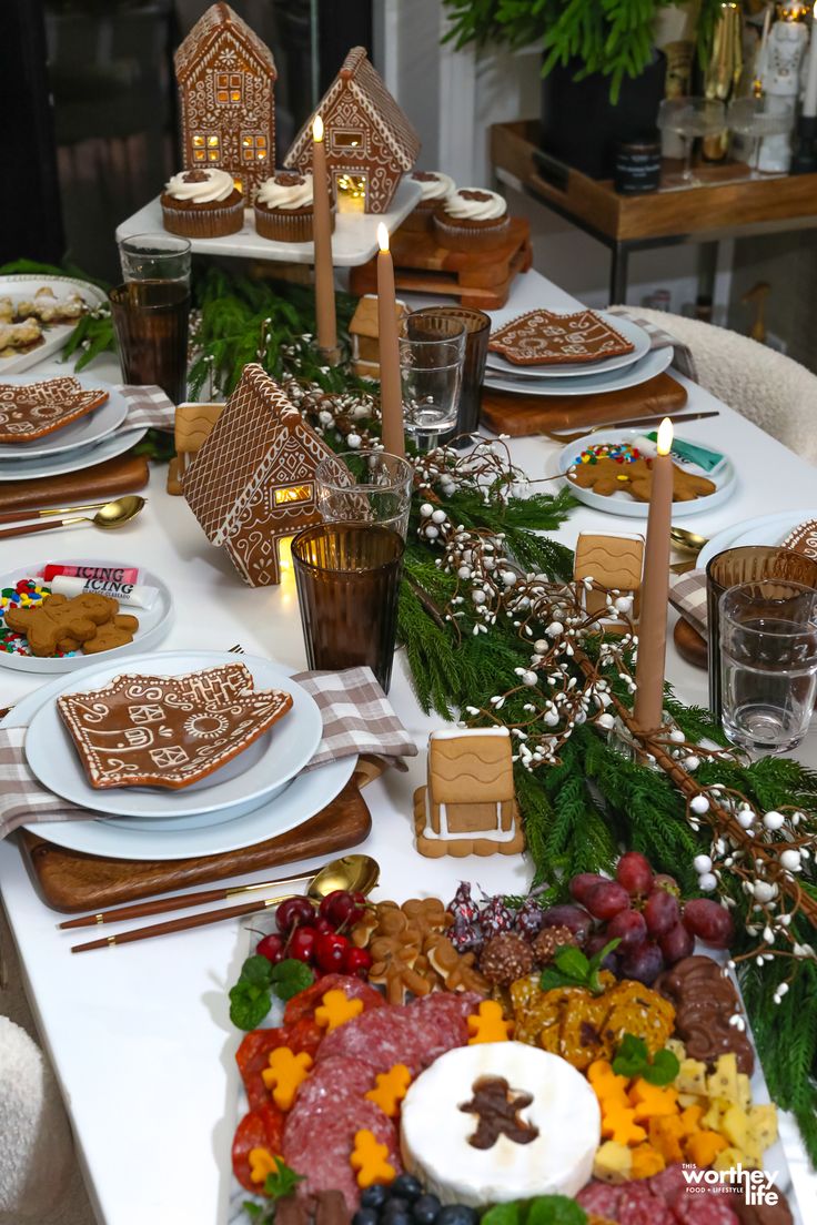 a table is set with gingerbread cookies, fruit and other holiday treats for the guests