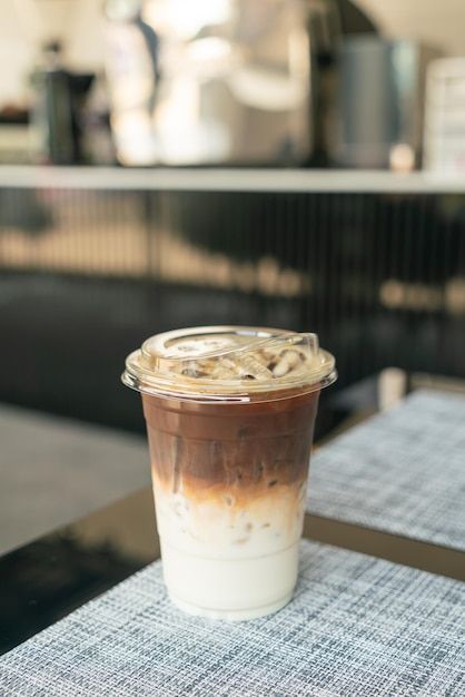 a plastic cup filled with food sitting on top of a table next to a napkin