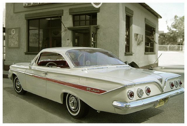 an old car parked in front of a building