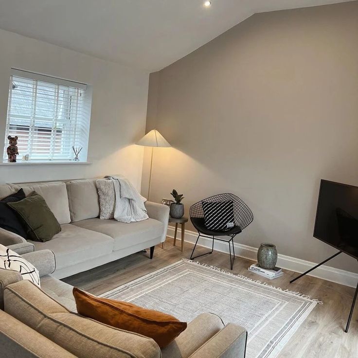 a living room filled with furniture and a flat screen tv