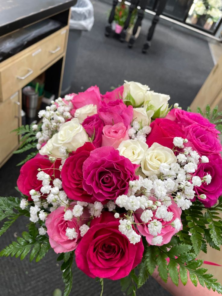 pink and white flowers are in a vase