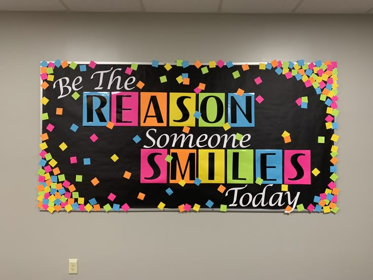 a bulletin board with the words be the reason someone smiles today written in multicolored letters