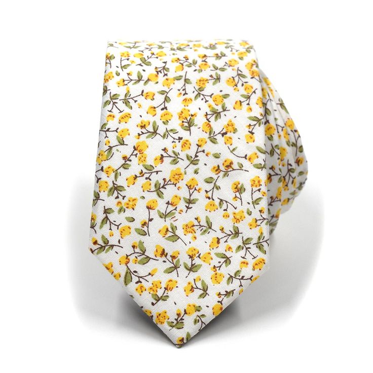 The floral marigold yellow tie rolled up Summer Wedding Cotton Ties, Spring White Cotton Suit And Tie Accessories, Spring Business Cotton Suit And Tie Accessories, White Cotton Ties For Gifts, Elegant Cotton Ties For Spring, Classic Cotton Ties As Gifts, Classic Cotton Ties For Gift, Cotton Standard Tie Perfect For Gifts, Classic Cotton Ties As Gift