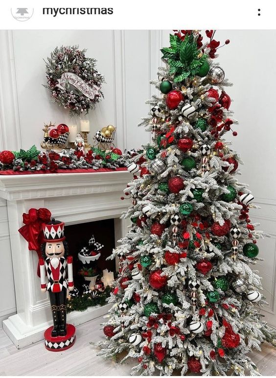 a white christmas tree with red and green ornaments