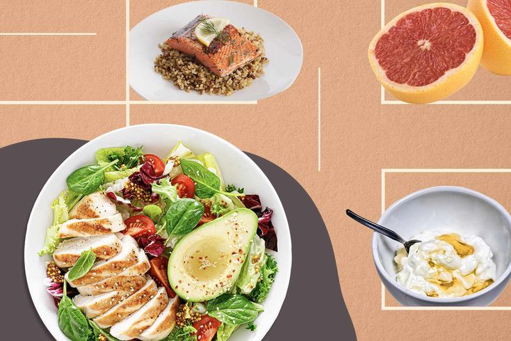 a table topped with plates of food and bowls of salad next to grapefruits