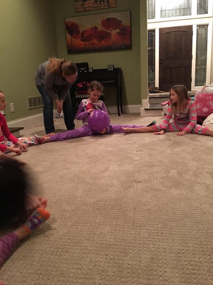 a group of children sitting on the floor playing with toys