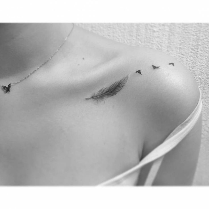 a woman's chest with three birds on it and one bird flying in the air