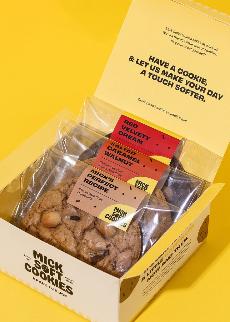 a box filled with cookies sitting on top of a yellow table