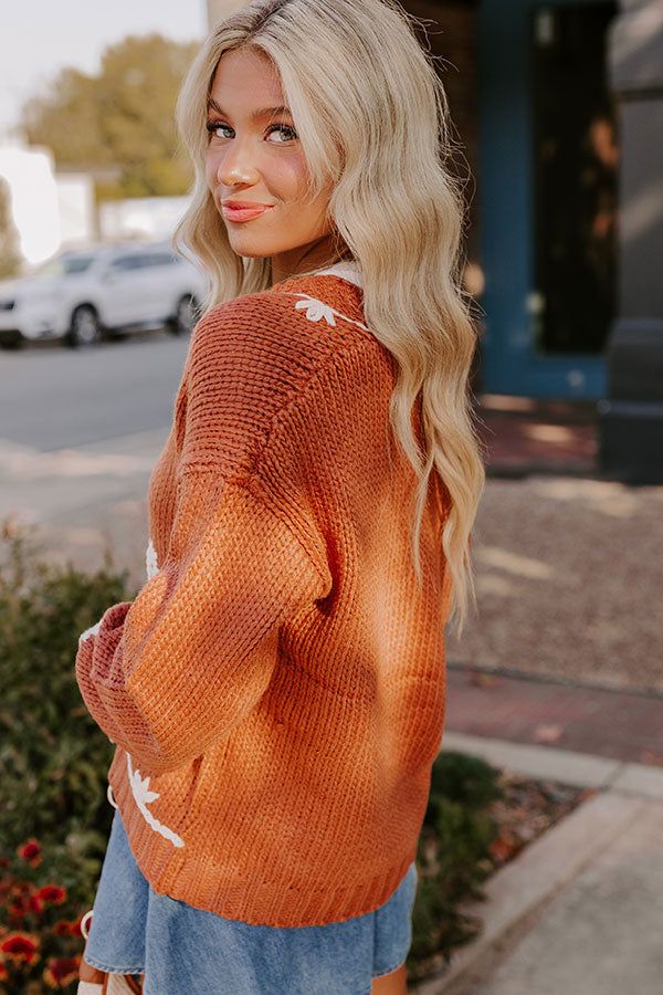 - Embrace the charm of autumn in this adorable embroidered cardigan! Whether you're out and about or sipping a latte in a cozy cafe, this floral cutie will keep you looking stylish. - Unlined knit material with ivory colored floral embroidery on the front Ivory colored embroidered trim - A v-cut neckline - Long sleeves with ribbed cuffs - Three button closure - A relaxed silhouette that ends in a straight hemline with a ribbed texture Cozy Cafe, Embroidered Trim, Embroidered Cardigan, Knee High Leather Boots, Ribbed Texture, V Cut, Out And About, V Cuts, Ivory Color