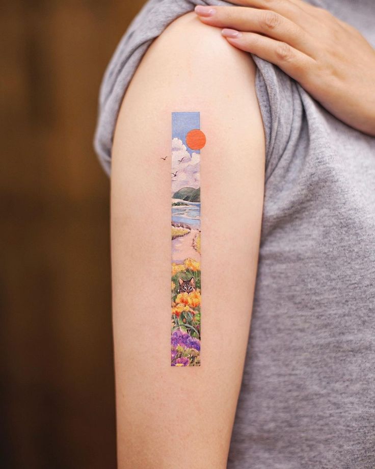 a woman's arm with a painting on it and an orange dot in the middle