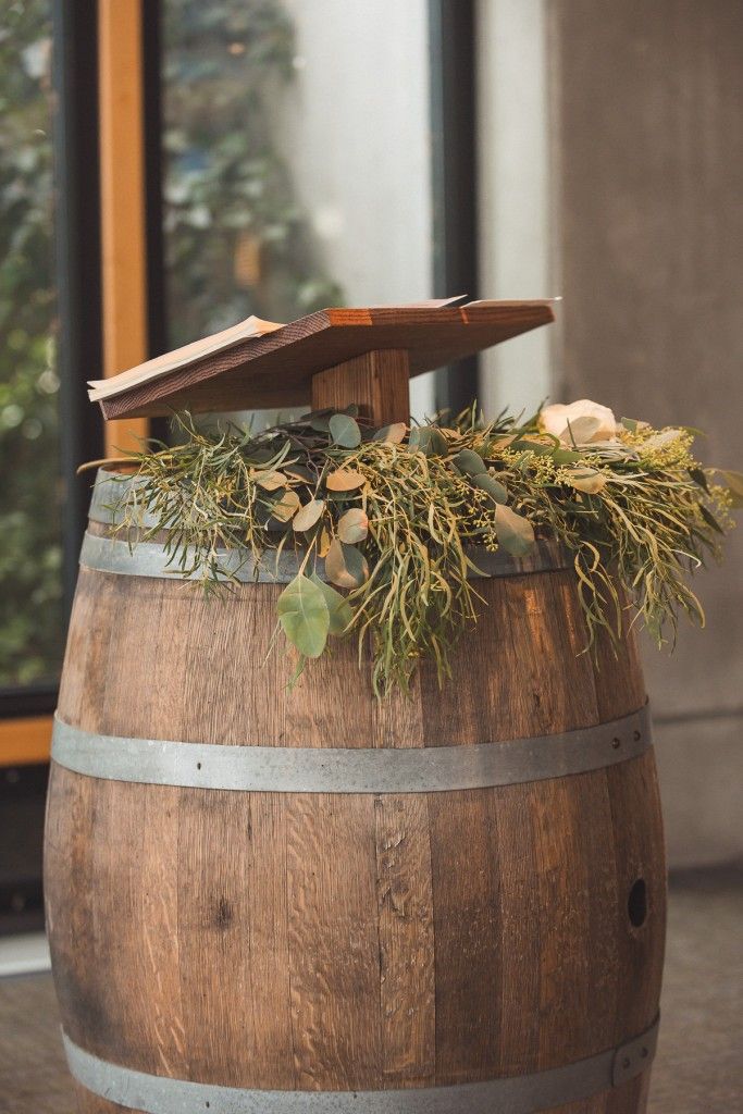 a wooden barrel with some plants growing out of it