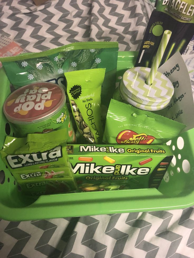 a green tray filled with various items on top of a bed