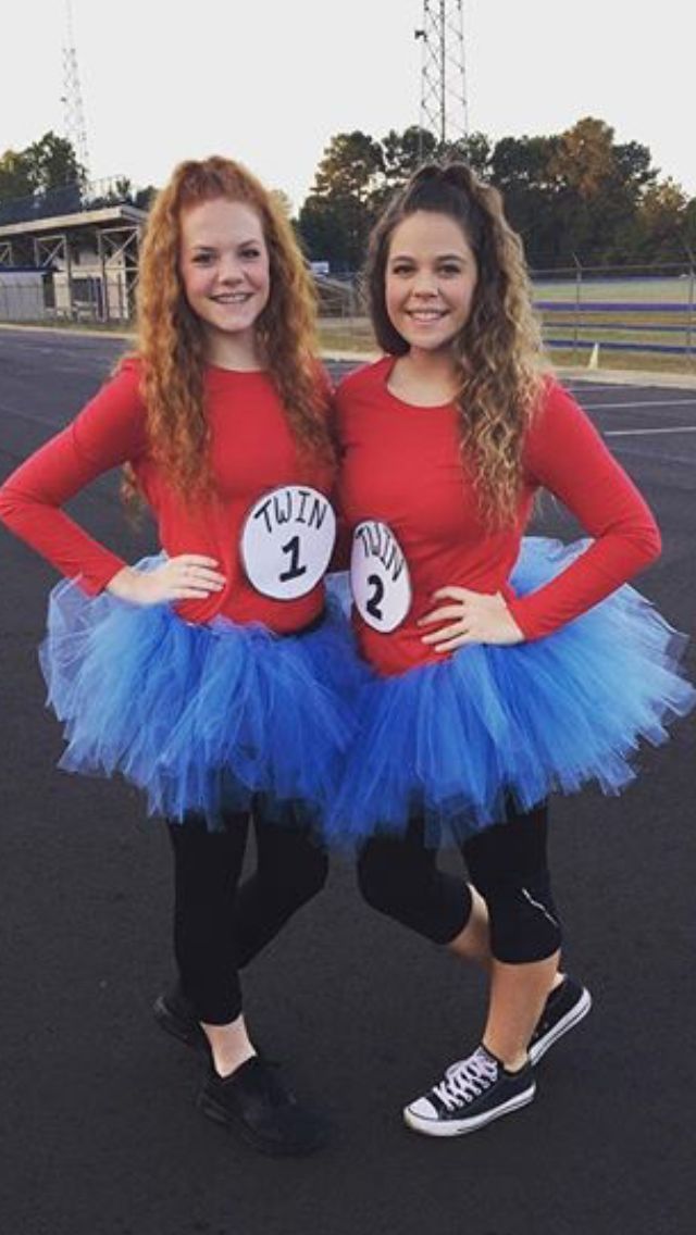 two girls dressed in costumes posing for the camera with their hands on their hipss